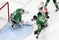 Calgary Flames' Andrew Mangiapane (88) is stopped by Dallas Stars goalie Anton Khudobin (35) as Alexander Radulov (47) defends during the first period in Game 1 of an NHL hockey Stanley Cup first-round playoff series, Tuesday, Aug. 11, 2020, in Edmonton, Alberta. (Jason Franson/The Canadian Press via AP)