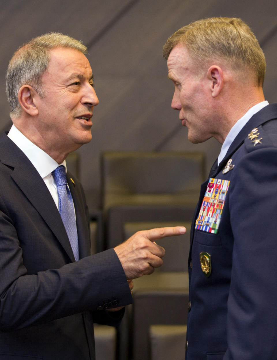 Turkish Defense Minister Hulusi Akar, left, speaks with Supreme Allied Commander Europe U.S. Air Force General Tod Wolters during a meeting of NATO defense ministers at NATO headquarters in Brussels, Wednesday, June 26, 2019. (AP Photo/Virginia Mayo)