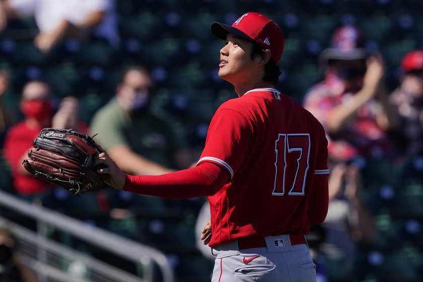 Los Angeles Angels pitcher Shohei Ohtani acknowledges the crowd after being pulled from the game against the Oakland Athletics during the second inning of a spring training baseball game, Friday, March 5, 2021, in Mesa, Ariz. (AP Photo/Matt York)
