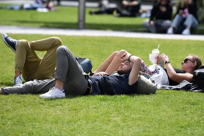 People relaxing in the sun in a park