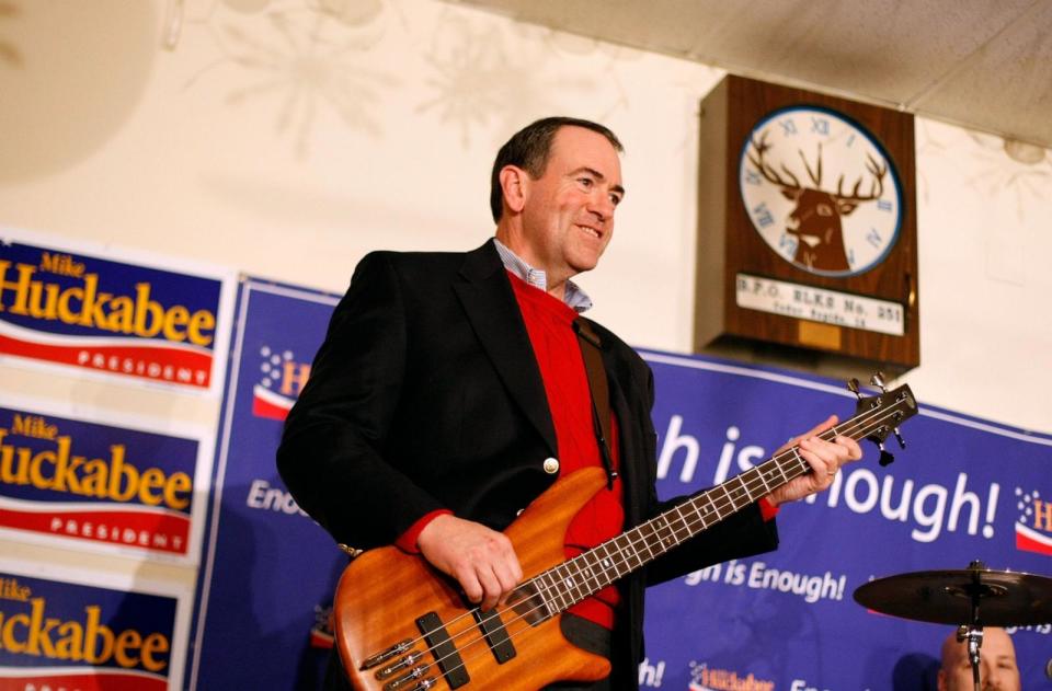 PHOTO: Republican presidential hopeful and former Arkansas governor Mike Huckabee plays bass guitar during a 'Meet Mike Huckabee' event at the Elk's Lodge, Jan. 1, 2008, in Cedar Rapids, Iowa.  (Justin Sullivan/Getty Images)