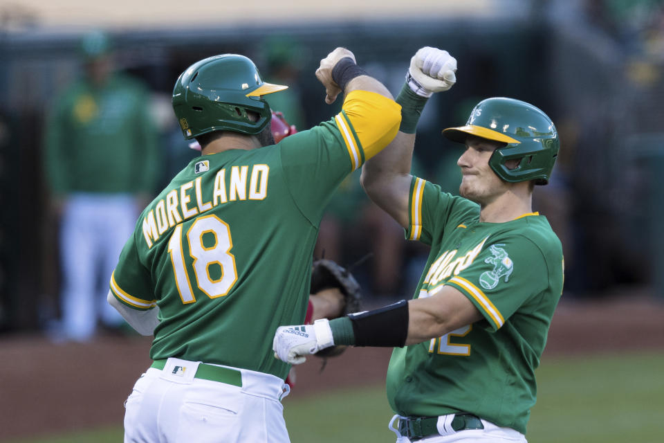 Oakland Athletics' Sean Murphy, right, celebrates with teammate Mitch Moreland (18) after hitting a solo home run against the Los Angeles Angels during the second inning of a baseball game in Oakland, Calif., Monday, June 14, 2021. (AP Photo/John Hefti)