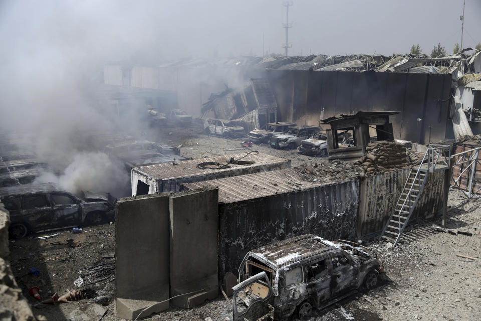 Burning cars are seen inside the Green Village after Monday's suicide bomb attack in Kabul, Afghanistan, Tuesday, Sept. 3, 2019. The attack occurred late Monday near the Green Village, home to several international organizations and guesthouses. (AP Photo/Rahmat Gul)