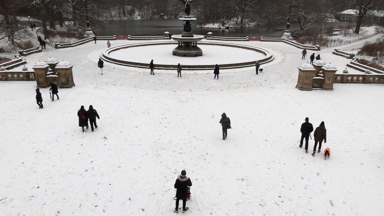 <div>People walk by the Bethesda Fountain as snow falls in Central Park on January 16, 2024, in New York City. The City received a rare accumulation of snow overnight. <strong>(Photo by Gary Hershorn/Getty Images)</strong></div>