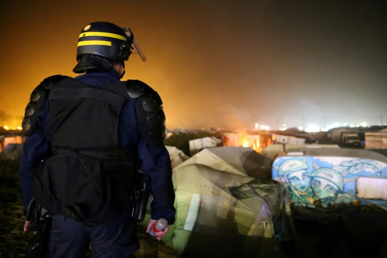 A French officer stands guard at the Calais "Jungle" camp in northern France, on October 25, 2016