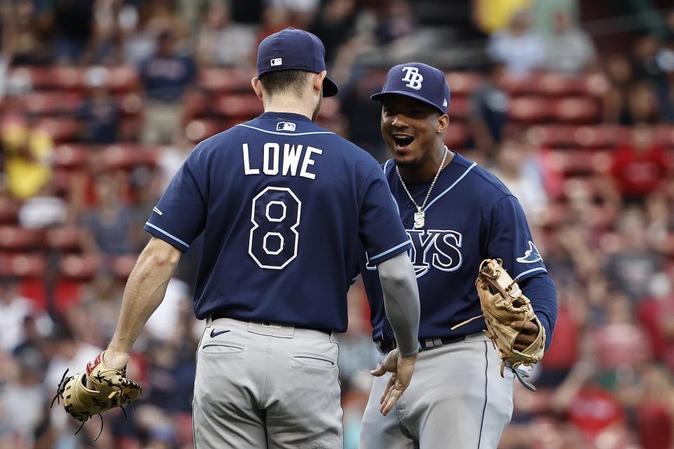 Tampa Bay Rays' Wander Franco celebrates with Brandon Lowe (8) after they defeated the Boston Red Sox in 10 innings of a baseball game Monday, Sept. 6, 2021, at Fenway Park in Boston. (AP Photo/Winslow Townson)