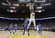 Golden State Warriors' Kevin Durant (35) drives for a dunk attempt past Oklahoma City Thunder's Andre Roberson, center left, during the first half of an NBA basketball game Wednesday, Jan. 18, 2017, in Oakland, Calif. (AP Photo/Marcio Jose Sanchez)