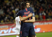 PSG's Edinson Cavani, behind, celebrates with teammate Moussa Diaby after scoring his third goal of the game, during the French League One soccer match between AS Monaco and Paris Saint-Germain at Stade Louis II in Monaco, Sunday, Nov. 11, 2018 (AP Photo/Claude Paris)