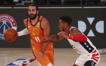 Phoenix Suns guard Ricky Rubio (11) is defended by Washington Wizards forward Troy Brown Jr. (6) during the second half of an NBA basketball game Friday, July 31, 2020, in Lake Buena Vista, Fla. (Kim Klement/Pool Photo via AP)