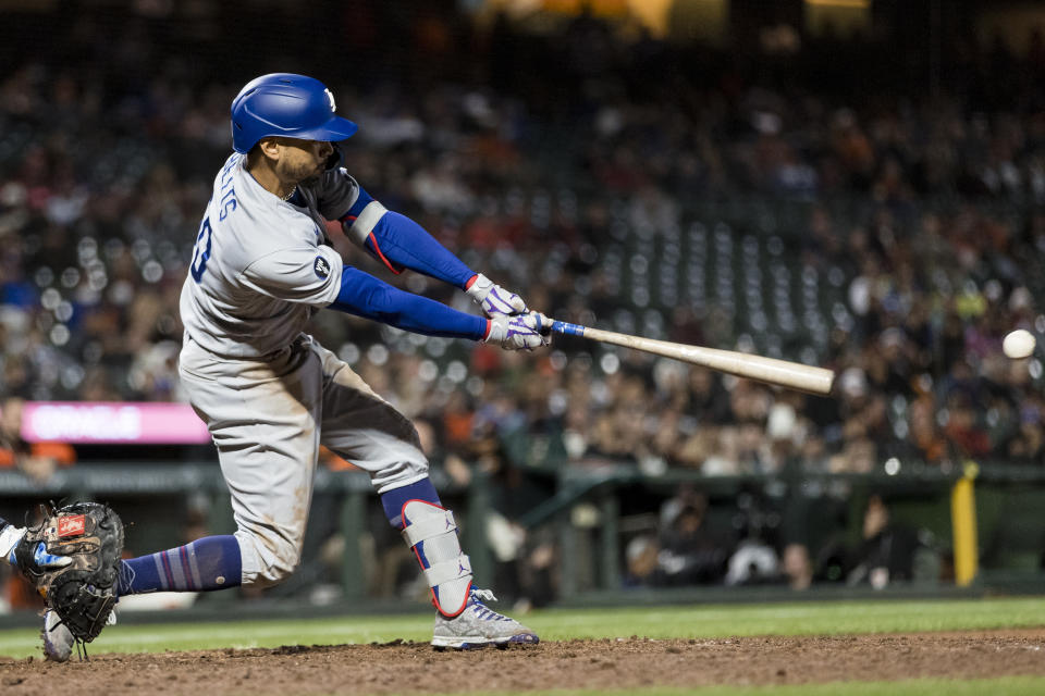 Los Angeles Dodgers' Mookie Betts hits an RBI double against the San Francisco Giants during the tenth inning of a baseball game in San Francisco, Sunday Sept. 18, 2022. (AP Photo/John Hefti)