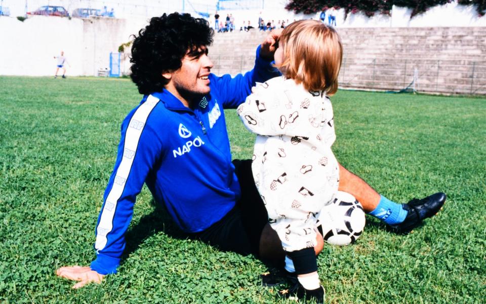 Diego Maradona of Napoli plays with his daughter Dalma after a training at the Centro Paradiso di Soccavo