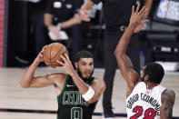 Boston Celtics' Jayson Tatum (0) is defended by Miami Heat's Andre Iguodala (28) during the second half of an NBA conference final playoff basketball game Friday, Sept. 25, 2020, in Lake Buena Vista, Fla. (AP Photo/Mark J. Terrill)