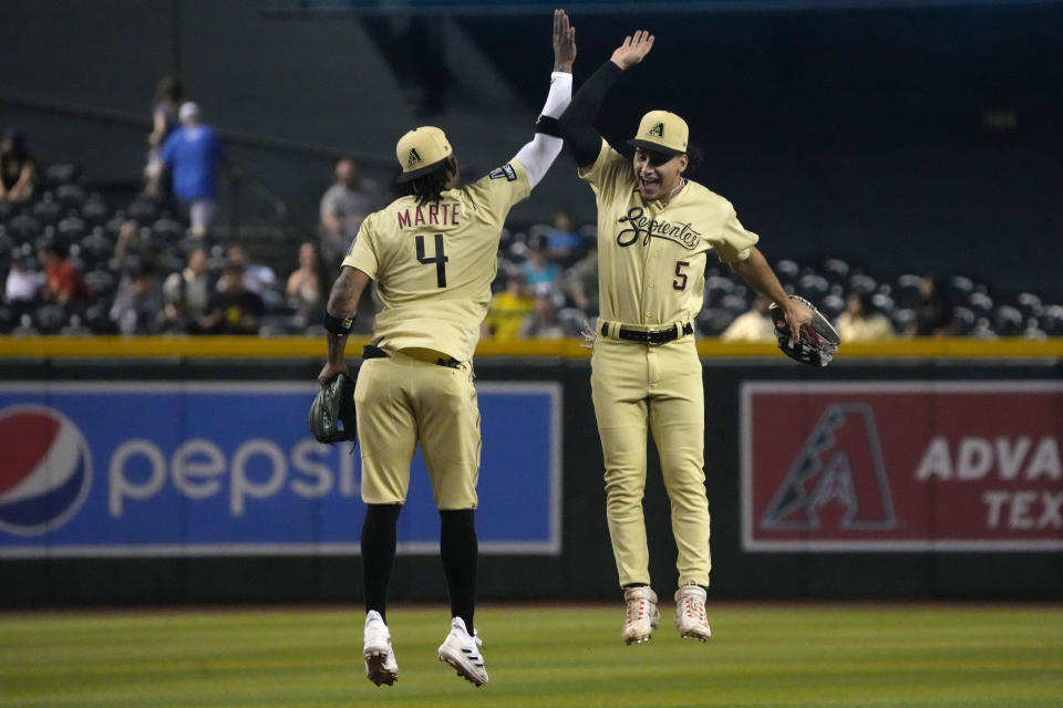 Arizona Diamondbacks' Ketel Marte (4) and Alek Thomas celebrate after the Diamondbacks defeated the San Francisco Giants 7-5 in a baseball game Friday, May 12, 2023, in Phoenix. (AP Photo/Rick Scuteri)