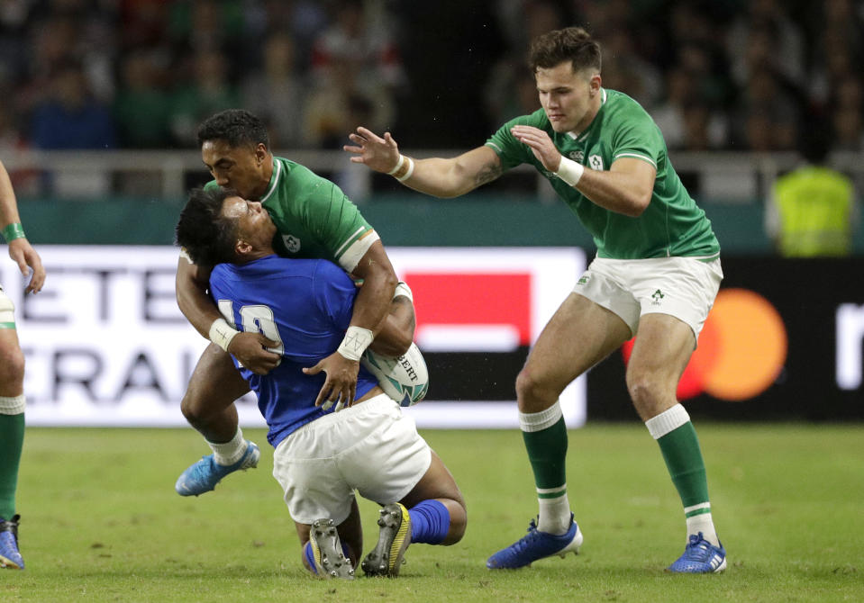 Ireland's Bundee Aki hits Samoa's Ulupano Seuteni in a high tackle during the Rugby World Cup Pool A game at Fukuoka Hakatanomori Stadium between Ireland and Samoa, in Fukuoka, Japan, Saturday, Oct. 12, 2019.Aki received a red card for this tackle. (AP Photo/Aaron Favila)