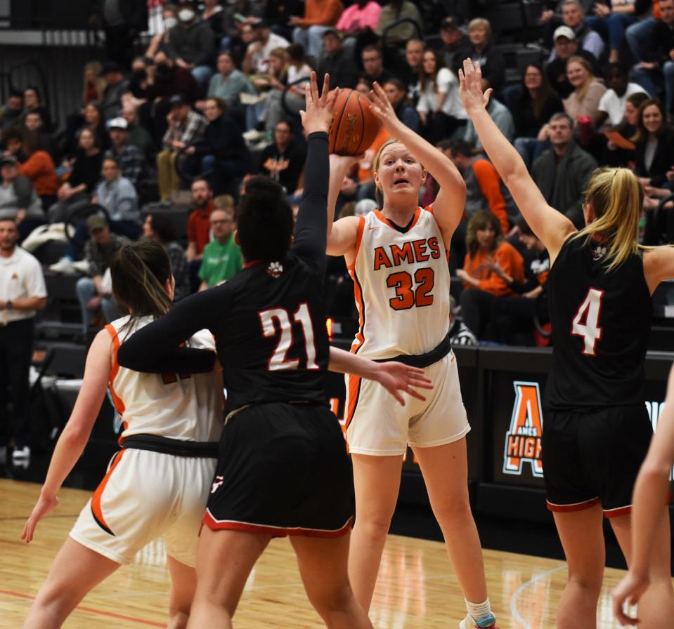Ames forward Morgan Wahl puts up a shot against the defense of Cedar Falls' Grace Knutson (4) and Aniah Burks (21) during the Little Cyclones' 71-31 loss  Friday.