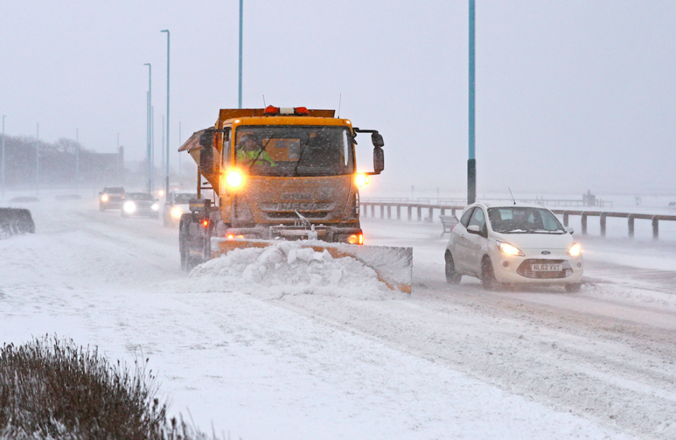<em>Snow ploughs clear drifts on the sea front road in Whitley Bay, North Tyneside (PA)</em>