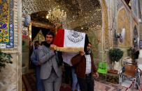 Mourners carry a coffin of a demonstrator who was killed at an anti-government protest overnight in Nassiriya, during a funeral in Najaf