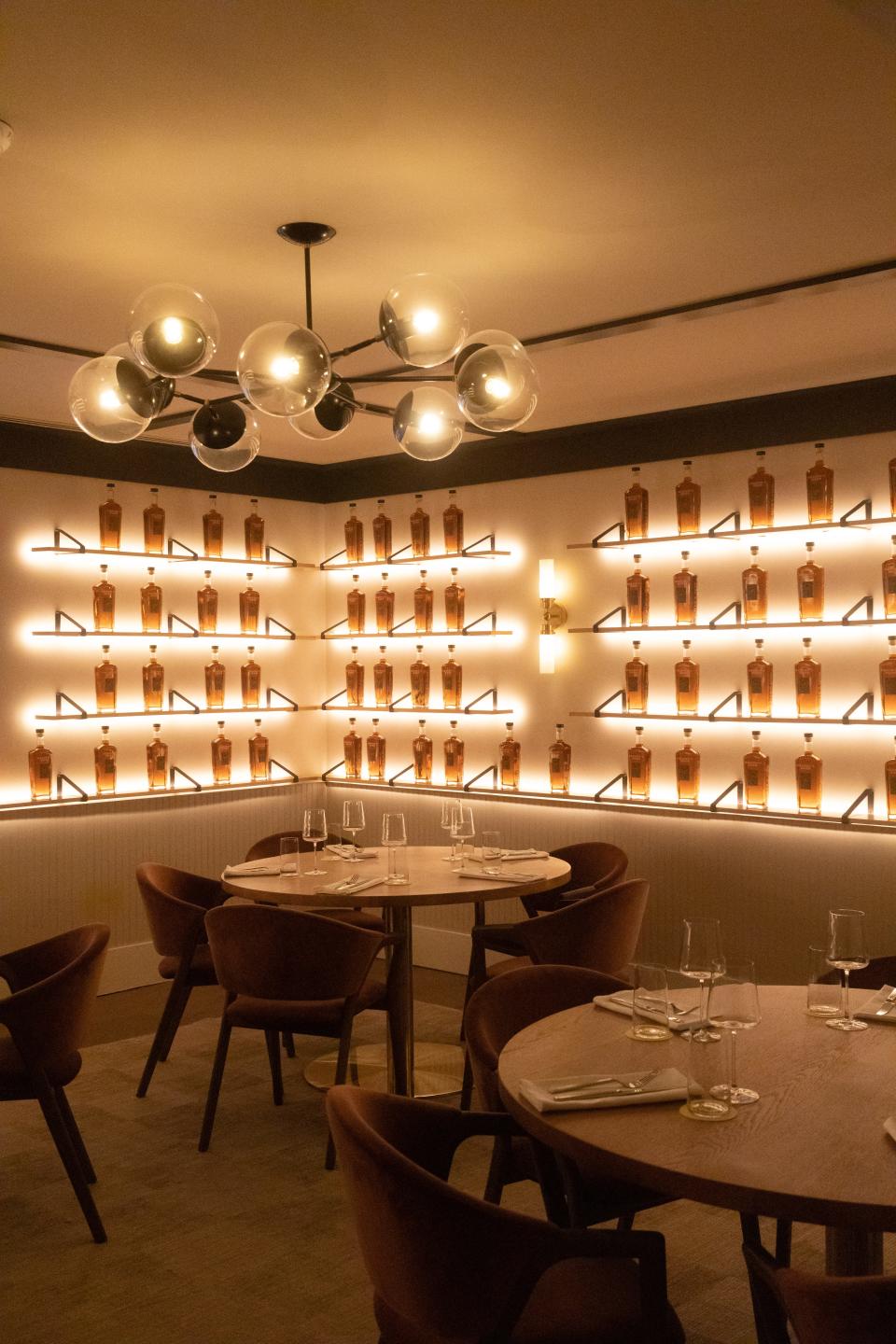 One of the dining rooms at Evelyn's in Nashville's Hutton Hotel features an eye-popping wall of the hotel's single barrel Heaven's door bourbon.