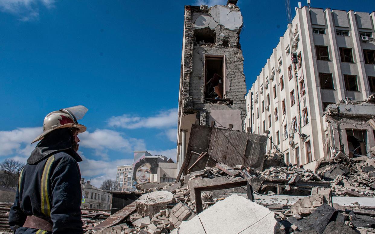 Rescue workers at the site of the ruined National Academy of State Administration building in Kharkiv. Russia has falsely claimed that it has only taken aim at military in Ukraine