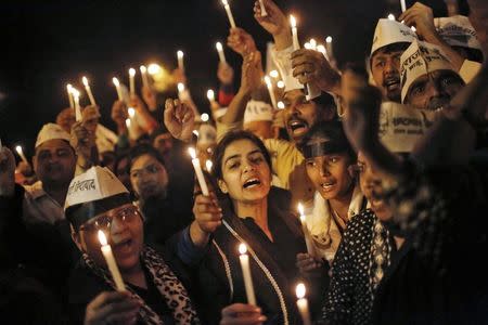 Supporters of Aam Aadmi (Common Man) Party (AAP) shout slogans as they participate in a candle light vigil during a protest against the rape of a female passenger, in New Delhi December 8, 2014. REUTERS/Anindito Mukherjee