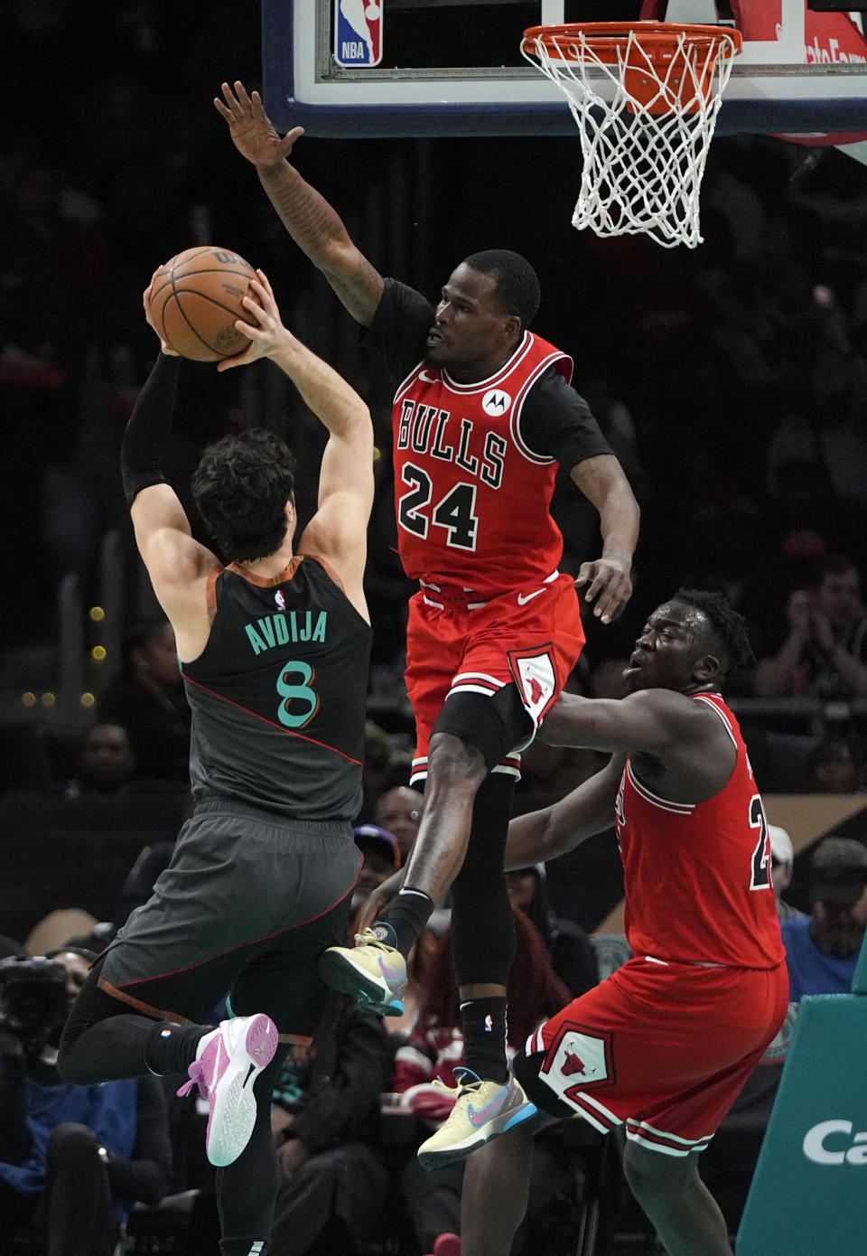 Chicago Bulls guard Javonte Green (24) defends against Washington Wizards forward Deni Avdija (8) during the first half of an NBA basketball game Friday, April 12, 2024, in Washington. (AP Photo/Mark Schiefelbein)