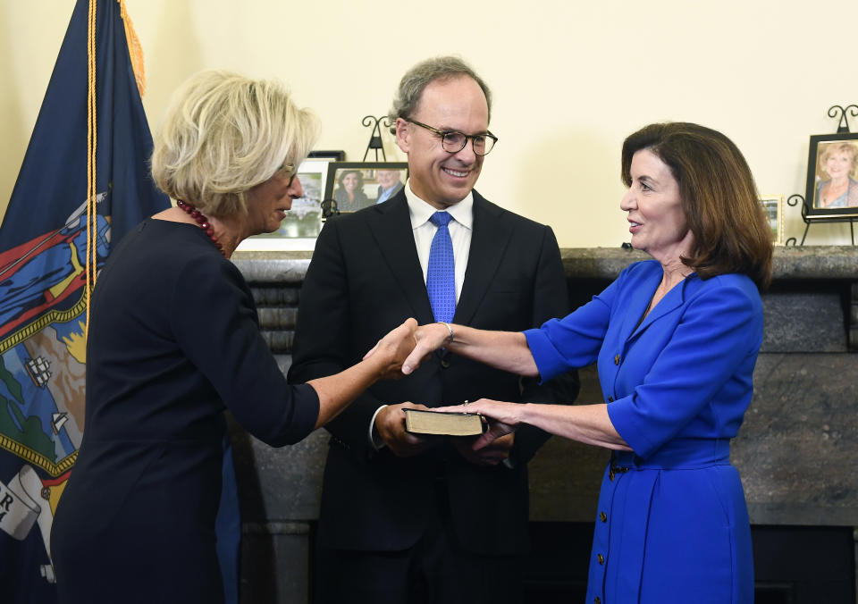 New York Chief Judge Janet DiFiore swears in Kathy Hochul as the first woman to be New York's governor during a swearing-in ceremony in the Red Room at the state Capitol, early Tuesday, Aug. 24, 2021, in Albany, N.Y. (AP Photo/Hans Pennink, Pool)