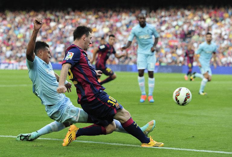 Granada's Colombian forward Jeison Murillo (L) vies with Barcelona's Argentinian forward Lionel Messi (R) during the Spanish league football match at the Camp Nou stadium in Barcelona on September 27, 2014