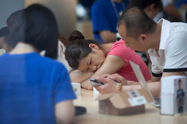 A man and a woman look at a smartphone at a shop. (AFP photo)