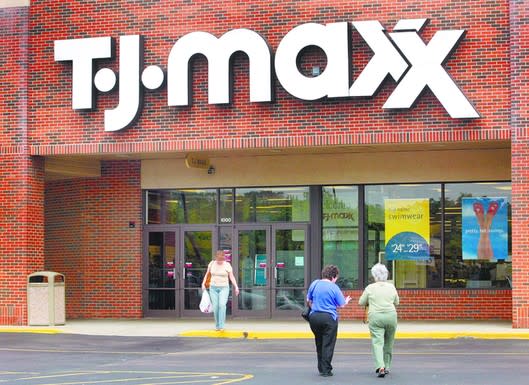TJ Maxx storefront with three shoppers outside
