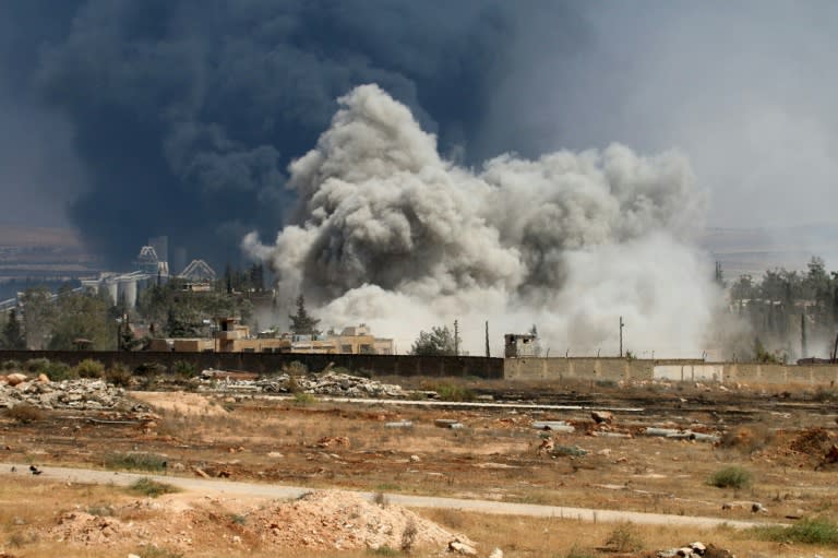 Smoke billows following air strikes by regime forces on rebel positions during intense fighting in Aleppo on August 18, 2016