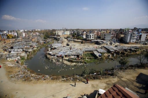 This file picture shows a stretch of the Bagmati river flanked by corrugated tin roof shanty huts in Kathmandu. Life in the city slums is particularly hazardous, where there are regular outbreaks of diarrhoea and cholera in the thousands of shanties on the banks of the river, which is used as a dump for toxic industrial and hospital waste