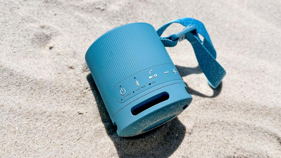 Sony SRS-XB100 sitting in the sand on the beach