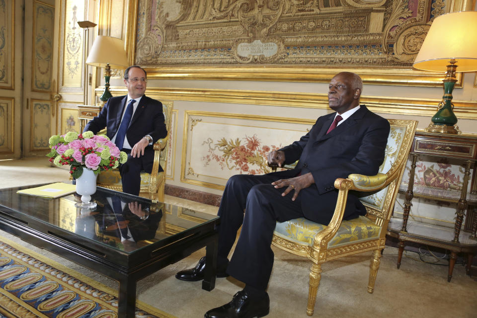 CAPTION CORRECTS AGE - FILE - French President Francois Hollande meets with Angolan President Jose Eduardo Dos Santos, at the Elysee Palace in Paris, Tuesday April 29, 2014. Former Angolan president Jose Eduardo dos Santos has died in a clinic in Barcelona, Spain after an illness, the Angolan government said. He was 79 years old and died following a long illness, the government said Friday, July 8, 2022 in an announcement on its Facebook page. (AP Photo/Remy de la Mauviniere, File)