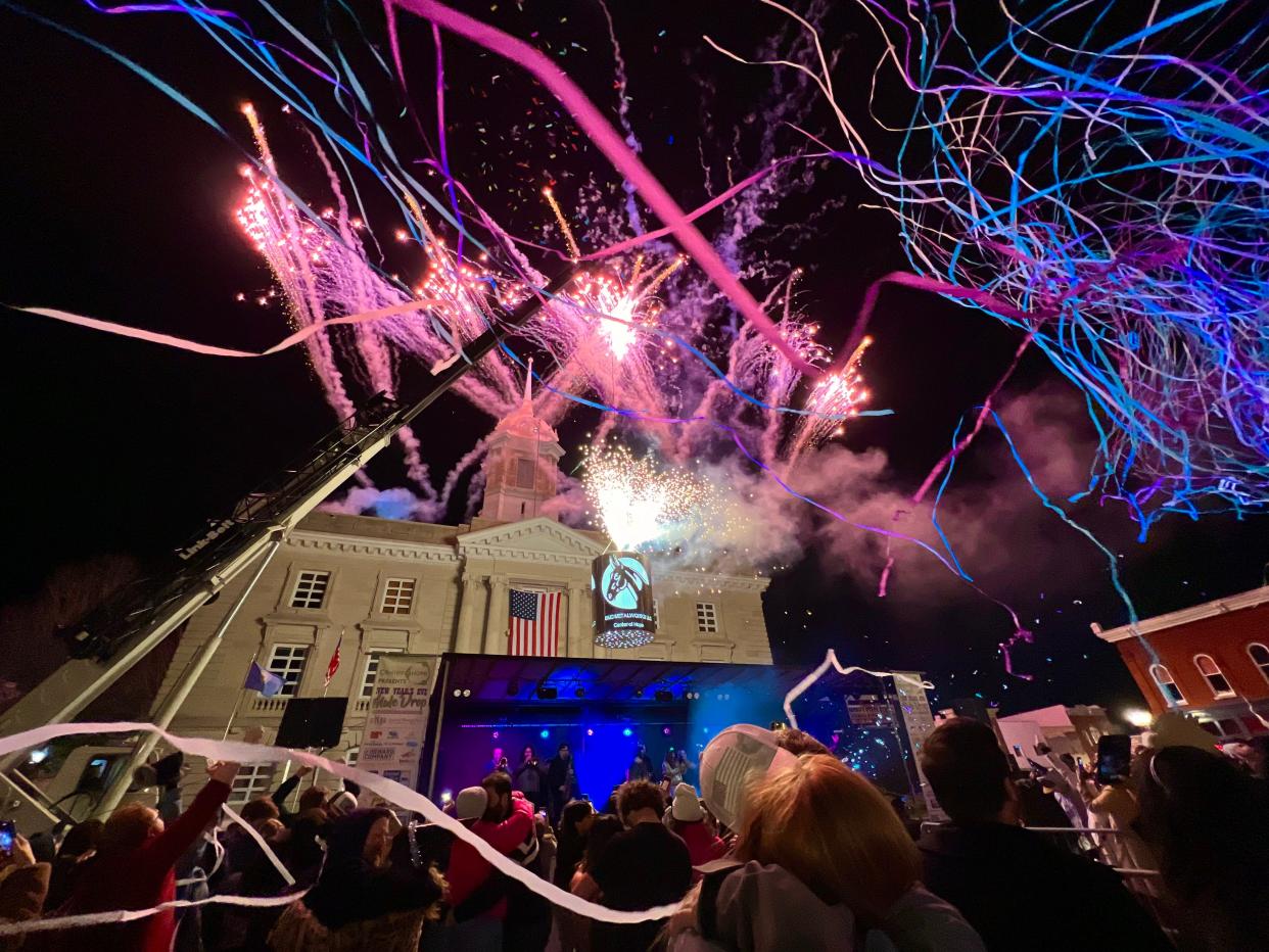 Fireworks ignite and streamers cascade over downtown Columbia during the fifth annual New Year's Eve Mule Drop on Sunday, Dec. 31, 2023.