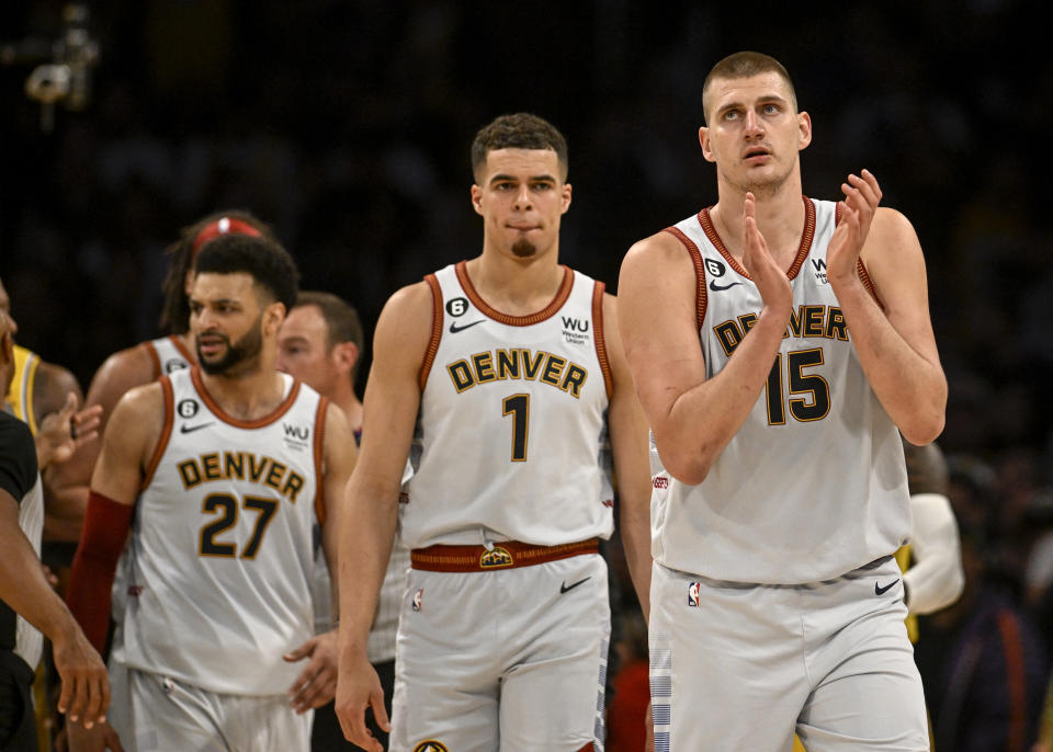 Nikola Jokic claps as he is trailed by Jamal Murray (27) and Michael Porter Jr. (1) on May 22. (Aaron Ontiveroz/The Denver Post)