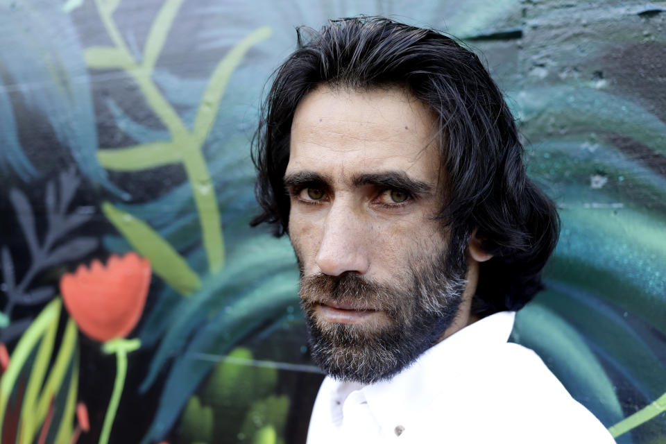 In this Nov. 19, 2019, photo, Behrouz Boochani, the Kurdish film-maker, writer and refugee who has documented life inside the Australian offshore immigration camp on Manus Island, poses for a portrait in Christchurch, New Zealand. (AP Photo/Mark Baker)