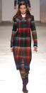 <p>The model masterfully mixed prints at Missoni in a plaid coat and printed dress. Minimal makeup and soft waves balanced out the vibrant look.</p>