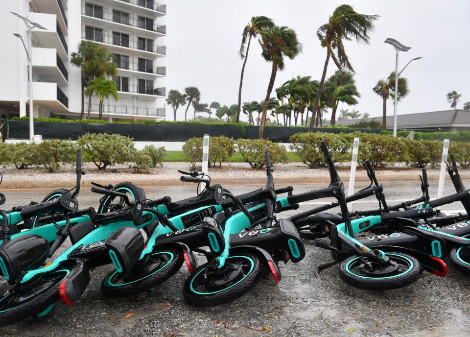 A row of rental scooters knocked over by the winds from Tropical Storm Nicole on Benjamin Franklin Dr. on Lido Key in Sarasota, Florida on Thursday, Nov. 10, 2022. 