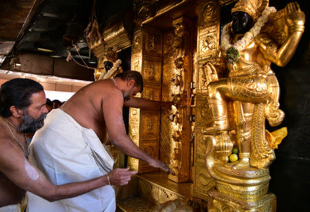 A priest closes the doors of sanctum sanctorum for performing religious rituals following the entry of two women in Sabarimala temple which traditionally bans the entry of women of menstrual age, in Pathanamthitta, January 2, 2019. REUTERS/Stringer/Files