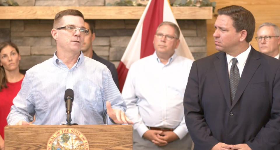 Florida's governor Ron DeSantis, right, stood by while a man spread Covid misinformation at a press conference. Source: facebook/Governor Ron DeSantis