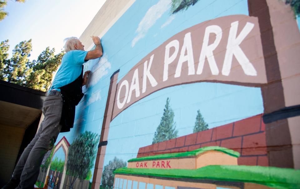 Stephen Coyle puts some finishing touches on a 18' x 11' mural on the north wall of the Oak Park Senior Center in Stockton on Nov. 7, 2023. Coyle, a retired artist who teaches art at the center, started the mural, with the help of 5 other local artists, on Oct. 9. Coyle asked people at the center what they'd like to see in the mural and incorporated their ideas in the design. Part of the mural, titled The Oak Park Experience, depicts Stockton founder Capt. Charles Weber and Moses Rodgers, the first African-American mining engineer in the 1800s. Another part feature composites of center members in activities that are offered at the center. An unveiling ceremony for the mural will be held on Nov. 20.
