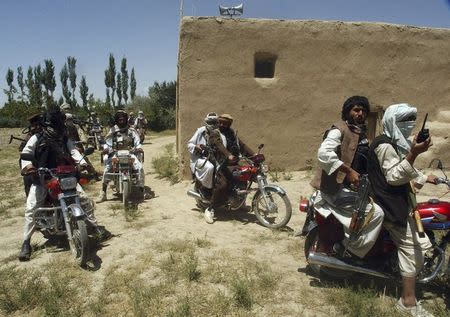 Taliban fighters ride on motorbikes in an undisclosed location in Afghanistan in this July 14, 2009 file photo. REUTERS/Stringer/Files