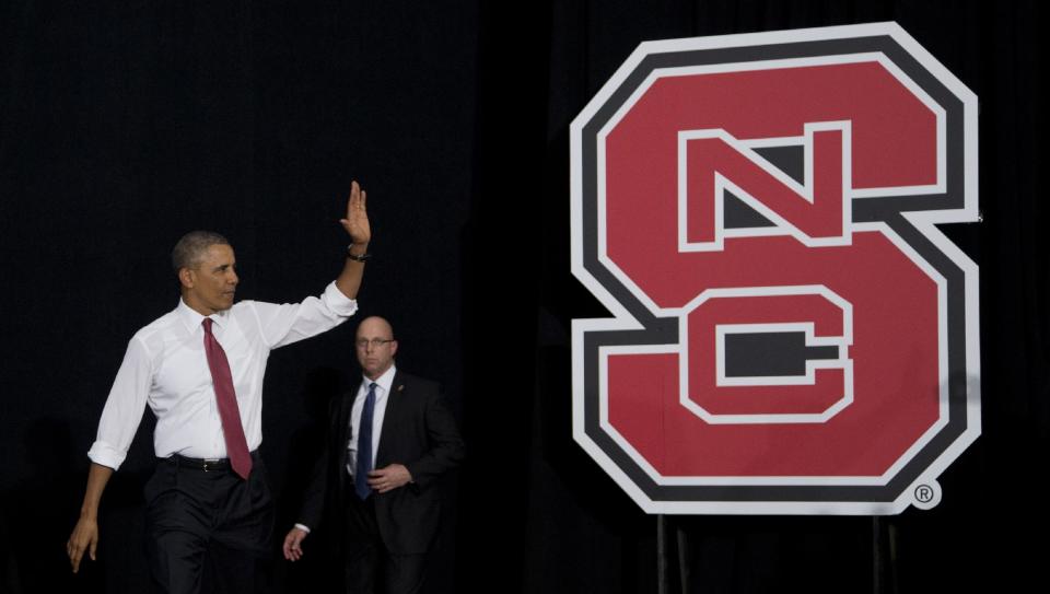 President Barack Obama waves as he arrives to talk about the economy, jobs and manufacturing, Wednesday, Jan. 15, 2014, at North Carolina State University in Raleigh, N.C. (AP Photo/Carolyn Kaster