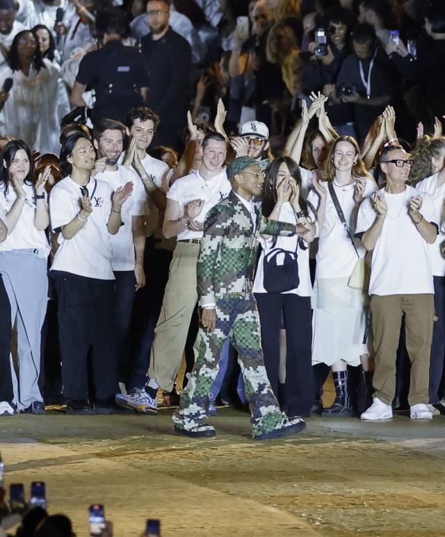 Louis Vuitton' fashion designer, singer Pharrell Williams, acknowledges the  audience at the end of the Louis Vuitton menswear spring/summer 2024 show  as part of Paris Fashion Week on the Pont Neuf, central