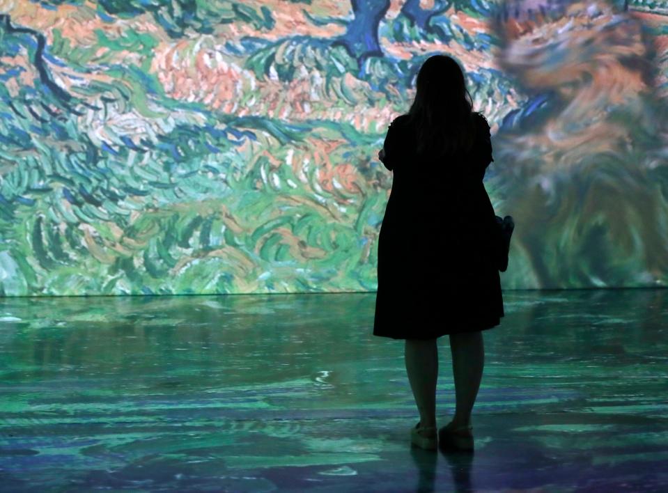 Guests explore 'Beyond Van Gogh: The Immersive Experience' during a preview event.