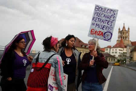 People protest on a bridge during a women's strike in Lausanne