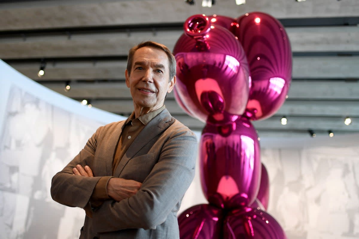 US artist Jeff Koons poses in front of his artwork titled "Balloon dog"  (AFP via Getty Images)