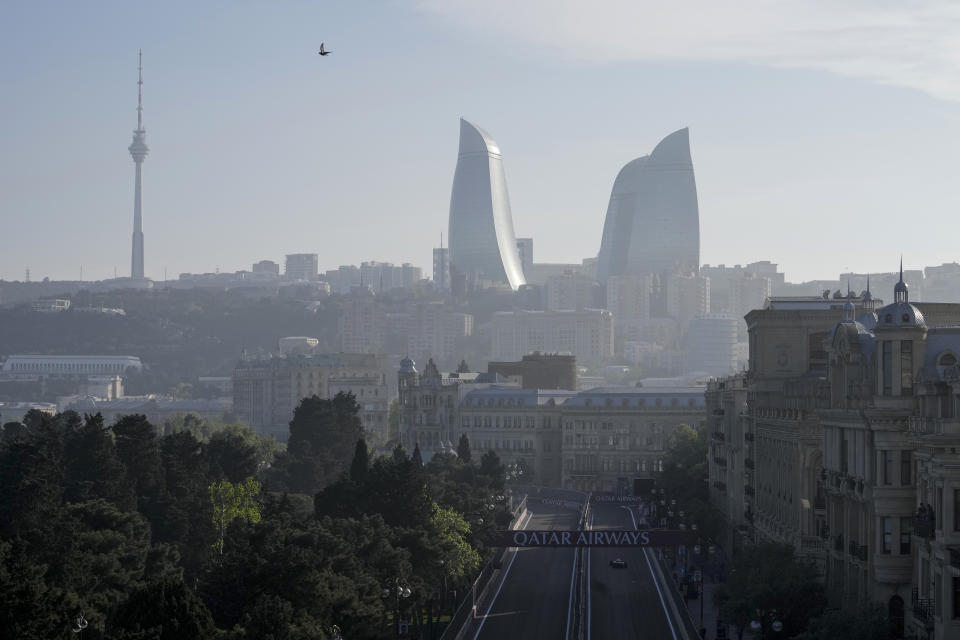 A bird flies over the Baku circuit, with the Flame Towers skyscrapers centre in the background, in Baku, Azerbaijan, Friday, April 28, 2023. The Formula One Grand Prix will be held on Sunday April 30, 2023. (AP Photo/Sergei Grits)