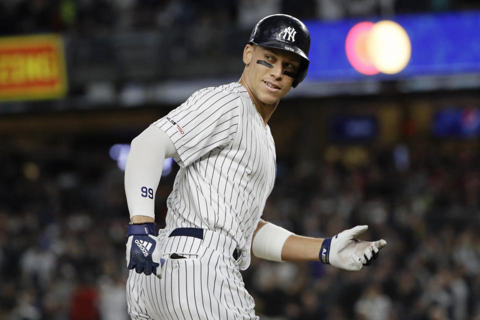 New York Yankees' Aaron Judge smiles at third base coach Phil Nevin as he runs the bases after hitting a two-run home run during the third inning of the team's baseball game against the Los Angeles Angels on Wednesday, Sept. 18, 2019, in New York. (AP Photo/Frank Franklin II)