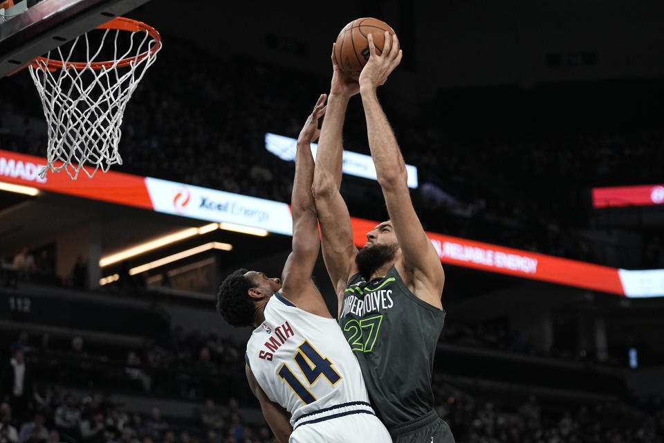 Minnesota Timberwolves center Rudy Gobert (27) goes up for a shot against Denver Nuggets guard Ish Smith (14) during the first half of an NBA basketball game, Sunday, Feb. 5, 2023, in Minneapolis. (AP Photo/Abbie Parr)